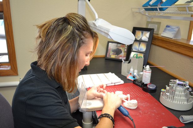 Finishing milled dental models at the Studio 32 lab.JPG