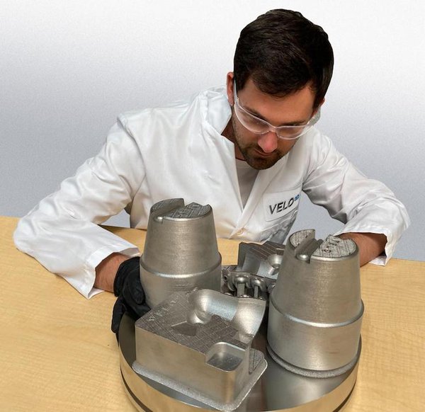 Engineer evaluating a M300 tool steel print of conformal cooled tooling and high pressure die casting inserts. Engineer evaluating a M300 tool steel print of conformal cooled tooling and high pressure die casting inserts.