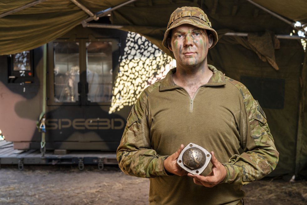 Australian Army solider holds part 3D printed in field Australian Army solider holds part 3D printed in field