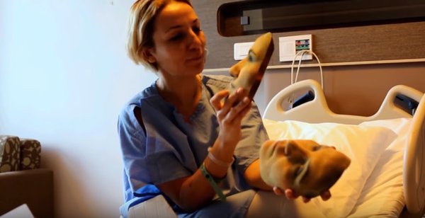 A patient presented with 3D printed masks to choose how she prefers her face to be changed. A patient presented with 3D printed masks to choose how she prefers her face to be changed.