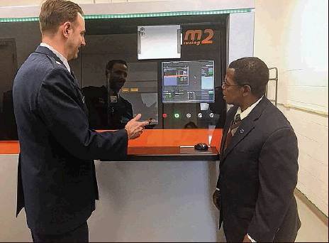 Concept Laser AFIT                Ryan O’Hara (left), assistant professor, Graduate School of Engineering and Management, AFIT, demonstrates the capabilities of the M2 to to Dr. Adedeji Ba...