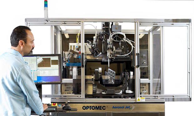 Optomec Aerosol Jet 5-axis      Aerosol Jet 5 Axis System, printing antennas and sensors on three cell phone inserts.
