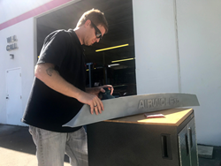 Airwolf 3d SEMA 2017                Airwolf 3D Artist and Sales Manager, Tyler Caros sands a 3D-printed spoiler designed for The 3D-Printed Hellcat Project by Airwolf 3D.