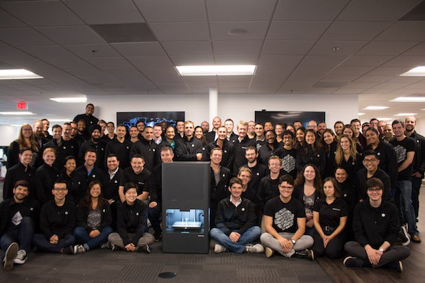 Markforged team with metal x      The Markforged team with the Metal X 3D printer.