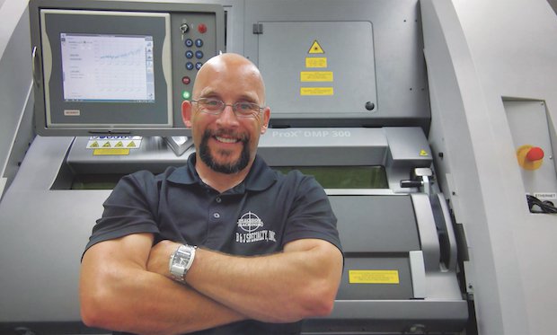 Jarod Rauch, B&J Specialty, IT & 3D Printing Manager with the 3D Systems ProX DMP 300.