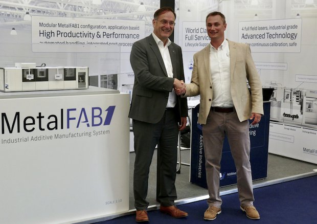 LPW Additive Industries      Left, Dr Phil Carroll shakes hands with Jan-Cees Santema, right. - Additive Industries