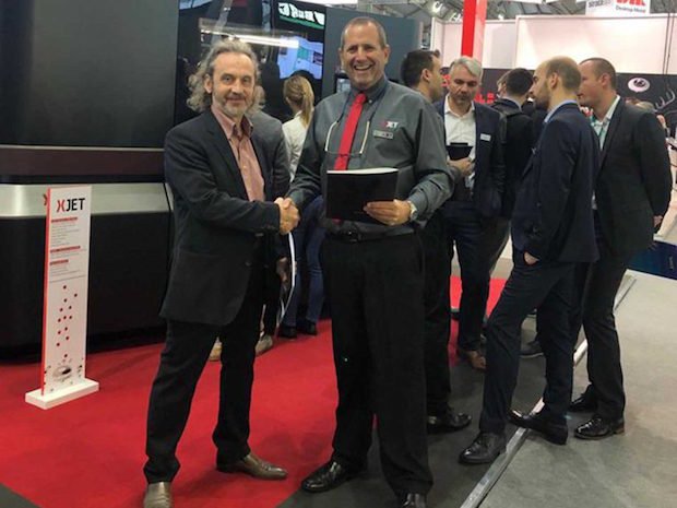 XJet AB Universal distributor      Andrei Boyarintsev, Managing Director AB Universal shakes hands on the new partnership agreement with XJet CBO Dror Danai.
