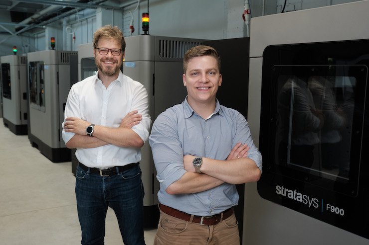 Craft AM Stratasys      AM Craft Co-founders Jānis Jātnieks and Didzis Dejus in front of the service provider’s four large-scale production-grade Stratasys F900 3D printers. - Reinis Inkens