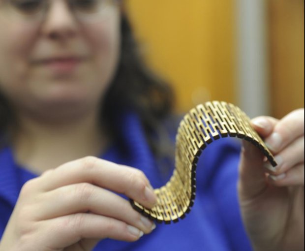 East Stroudsburg University      Evelyn Barone demonstrates how a solid piece of plywood can be bent after laser cutting - Keith R. Stevenson/ Pocono Record