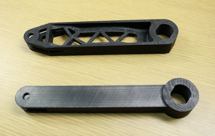 Original (below) and topology-optimized (above) designs, printed for visual comparison in ABS. Final part could be 3D printed in stainless steel.png