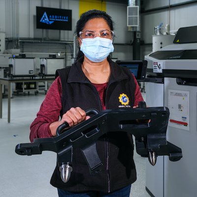General Motors Additive Manufacturing Senior Engineer Malini Dusey holds tools made at the GM Additive Industrialization Center using a 3D printer at the GM Tech Center in Warren, Michigan. (Photo by Steve Fecht for General Motors)