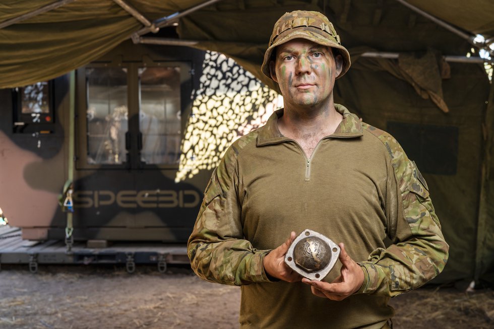 Australian Army solider holds part 3D printed in field
