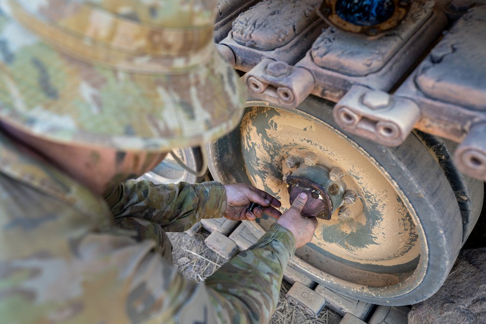 Soldier installing SPEE3D printed Wheel Bearing