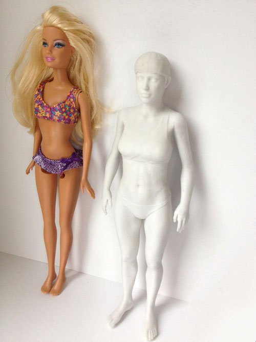 Regular Barbie stood next to the 3D printed "normal" Barbie