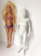 Regular Barbie stood next to the 3D printed "normal" Barbie