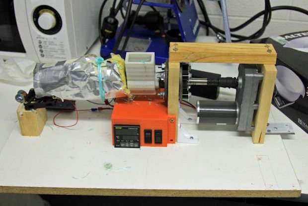 Small pieces of cut up rope go into this DIY machine to be turned into filament.